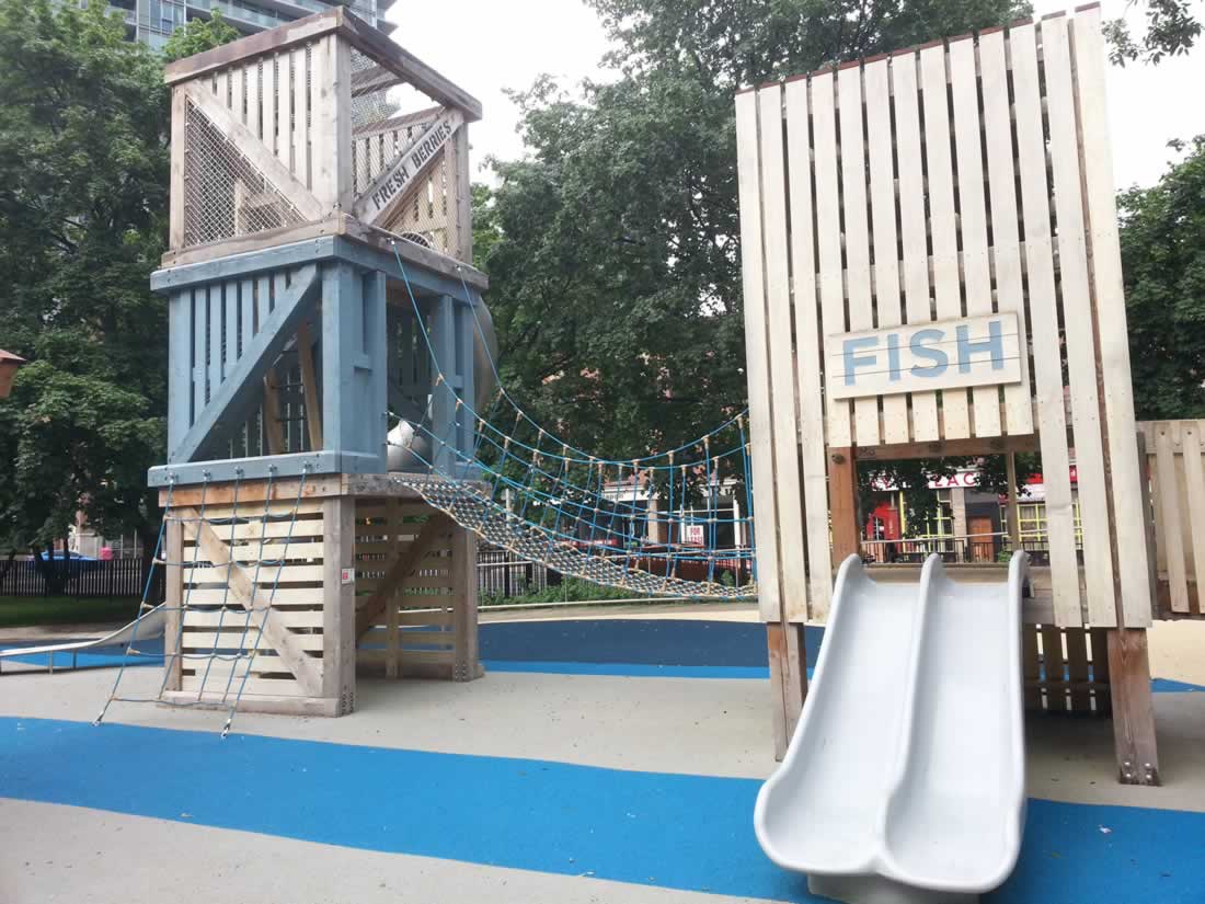 Small slides and rope bridge at St. James Park playground in Toronto