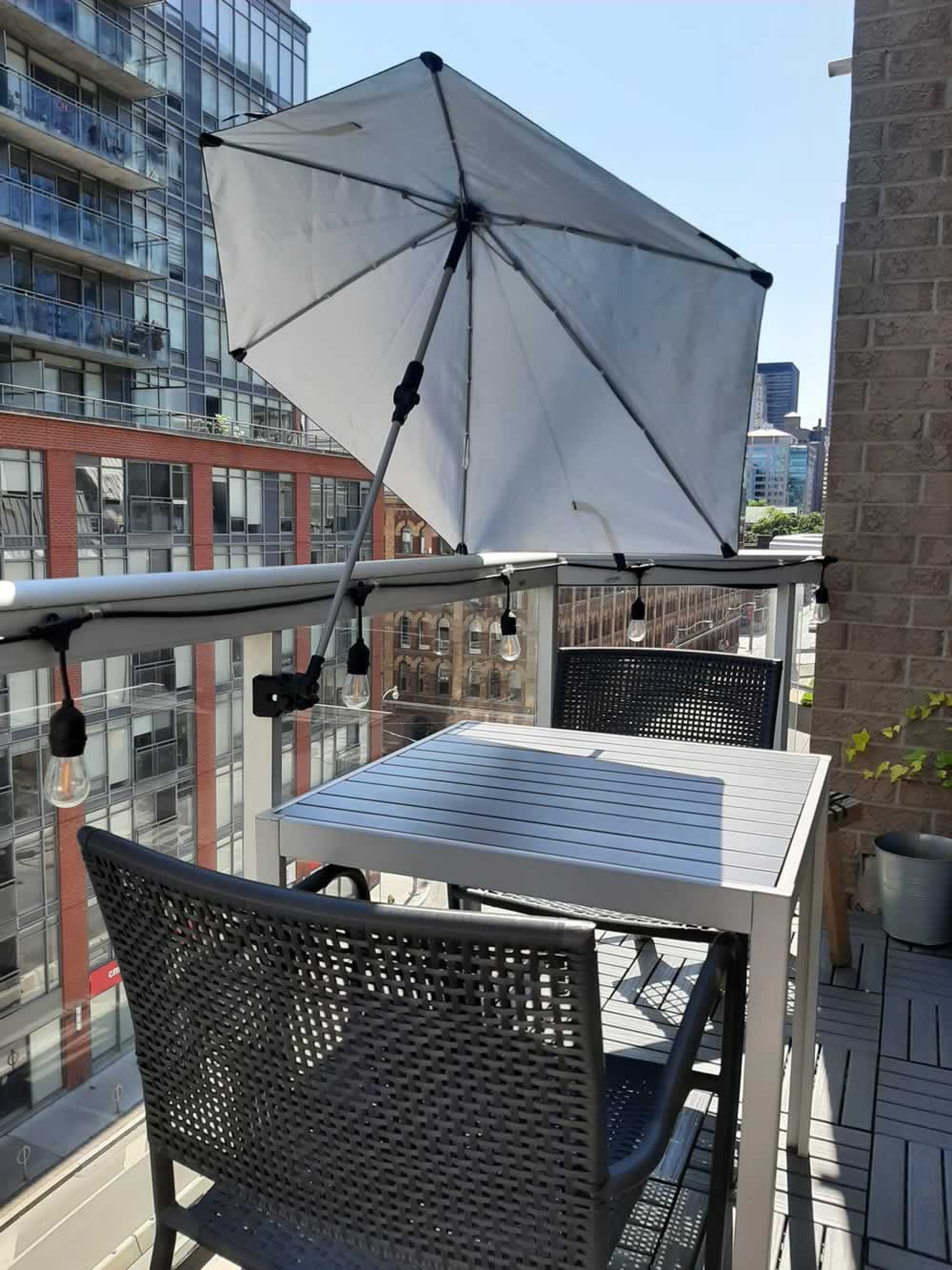 Balcony umbrella providing shade on table.