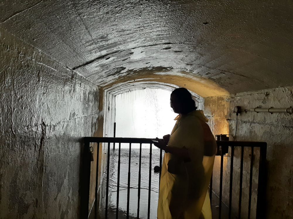 Woman stands at the portal opening for Journey Behind the Falls in Niagara Falls, Ontario.