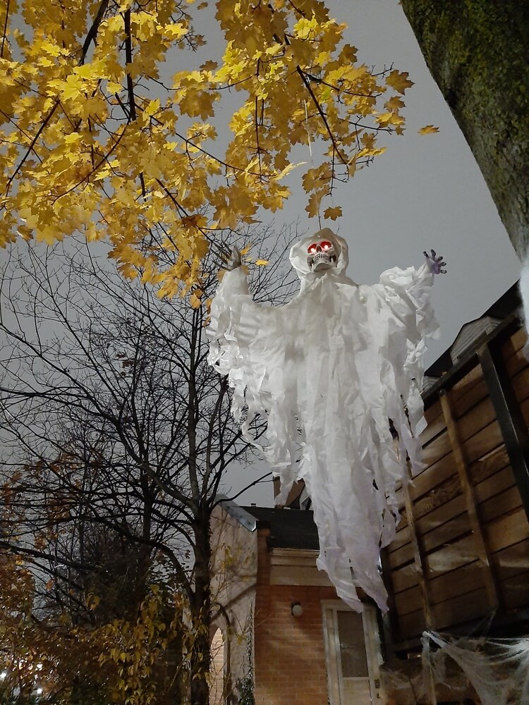 Hanging ghost in downtown Toronto during Halloween.