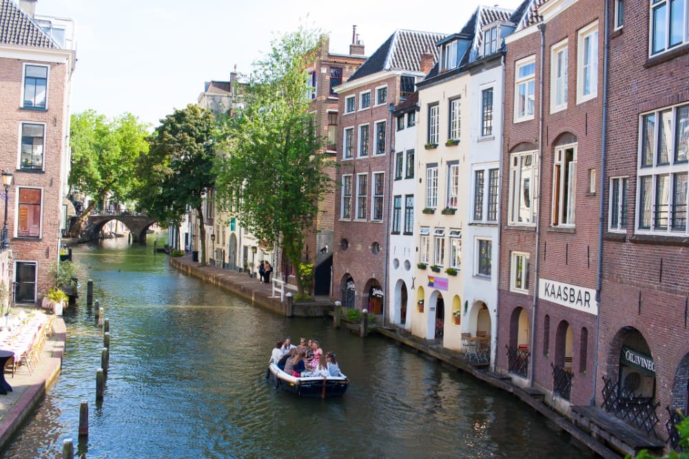 A boat riding along Oudegracht in Utrecht, Netherlands.