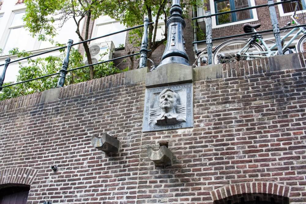 View from Utrecht canal tour: Face sculpture on canal walls.